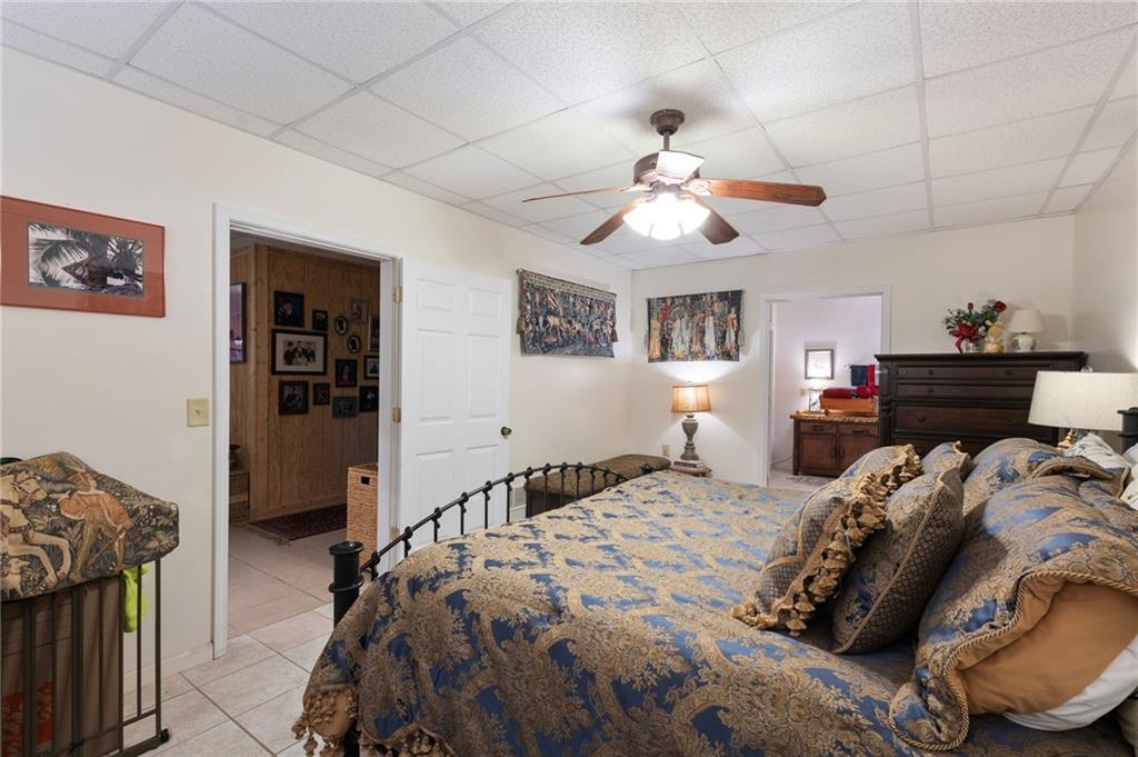 103 Twin Lakes Road Blue Ridge, GA 30513 - Photo 50 of 71 a bedroom with a bed and a chandelier