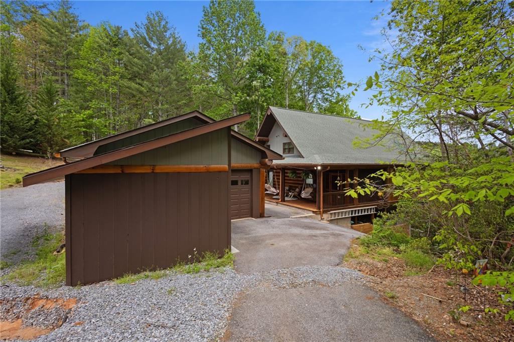 103 Twin Lakes Road Blue Ridge, GA 30513 - Photo 58 of 71 a view of a house with a yard plants and large tree