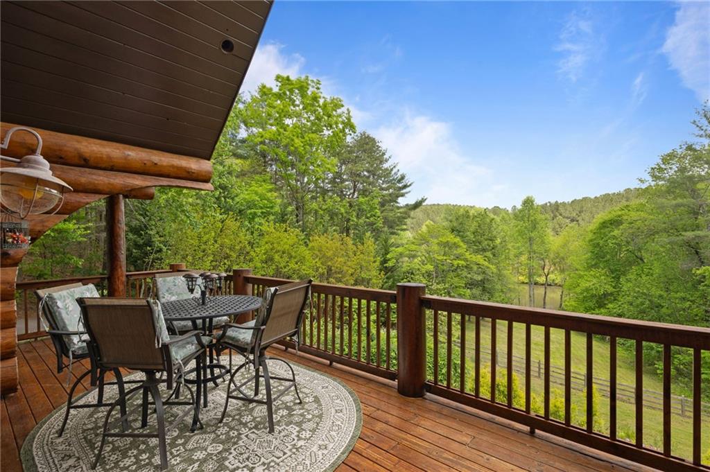 103 Twin Lakes Road Blue Ridge, GA 30513 - Photo 8 of 71 a view of a chair and table in the balcony