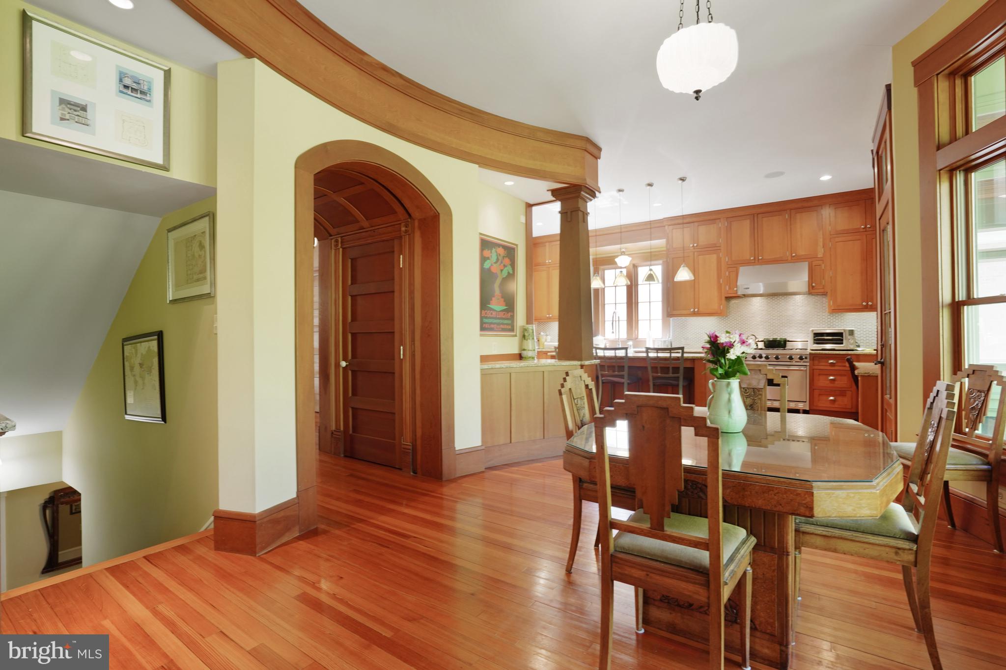 5402 Tuscarawas Road Bethesda, MD 20816 - Photo 16 of 55 a dining room with wooden floor a chandelier a wooden table and chairs