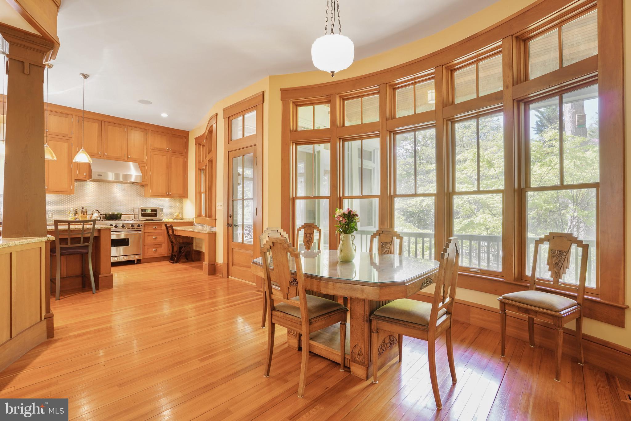 5402 Tuscarawas Road Bethesda, MD 20816 - Photo 18 of 55 a view of a dining room with furniture large windows and wooden floor
