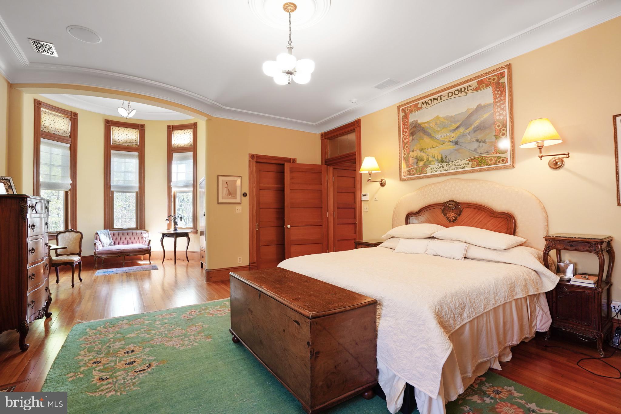 5402 Tuscarawas Road Bethesda, MD 20816 - Photo 24 of 55 a spacious bedroom with a bed a table and large windows