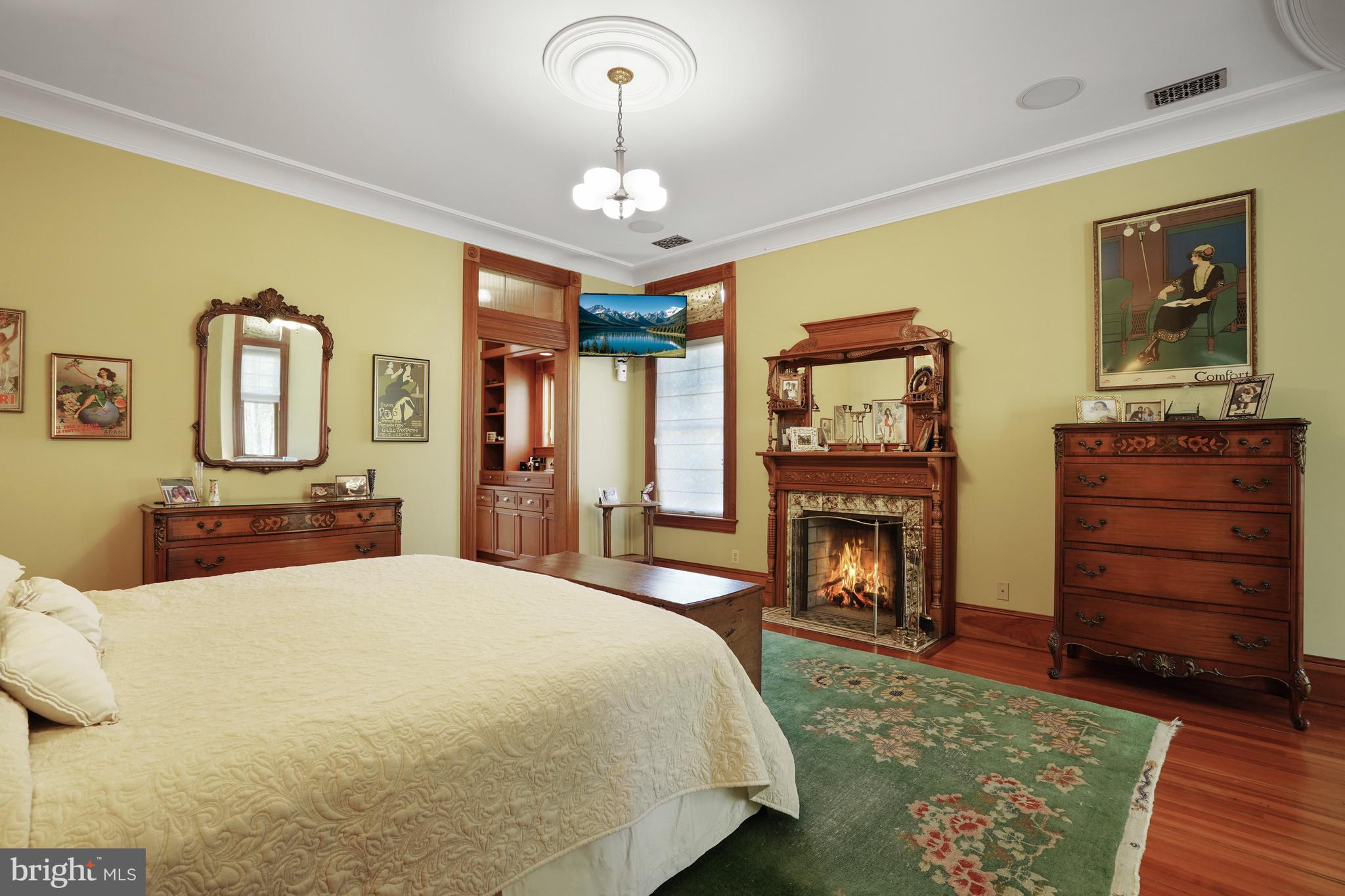 5402 Tuscarawas Road Bethesda, MD 20816 - Photo 25 of 55 a bedroom with a bed and dresser with mirror