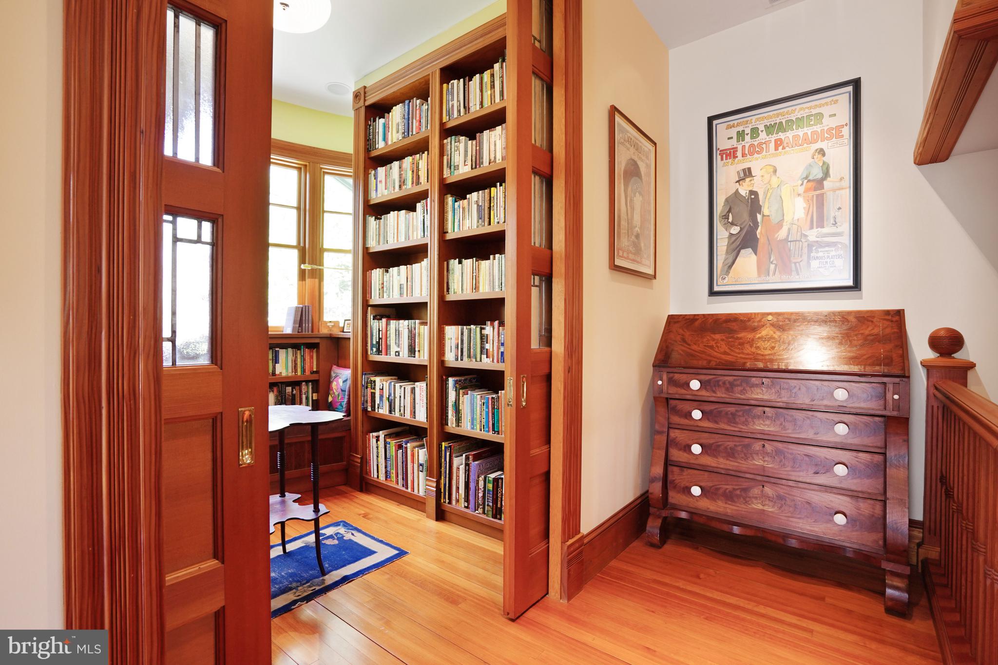 5402 Tuscarawas Road Bethesda, MD 20816 - Photo 31 of 55 a room with bookshelf and wooden floor