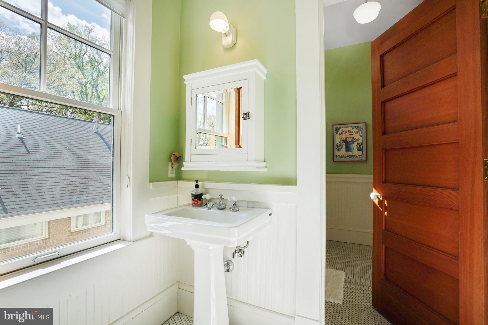 5402 Tuscarawas Road Bethesda, MD 20816 - Photo 35 of 55 a bathroom with a sink and a mirror
