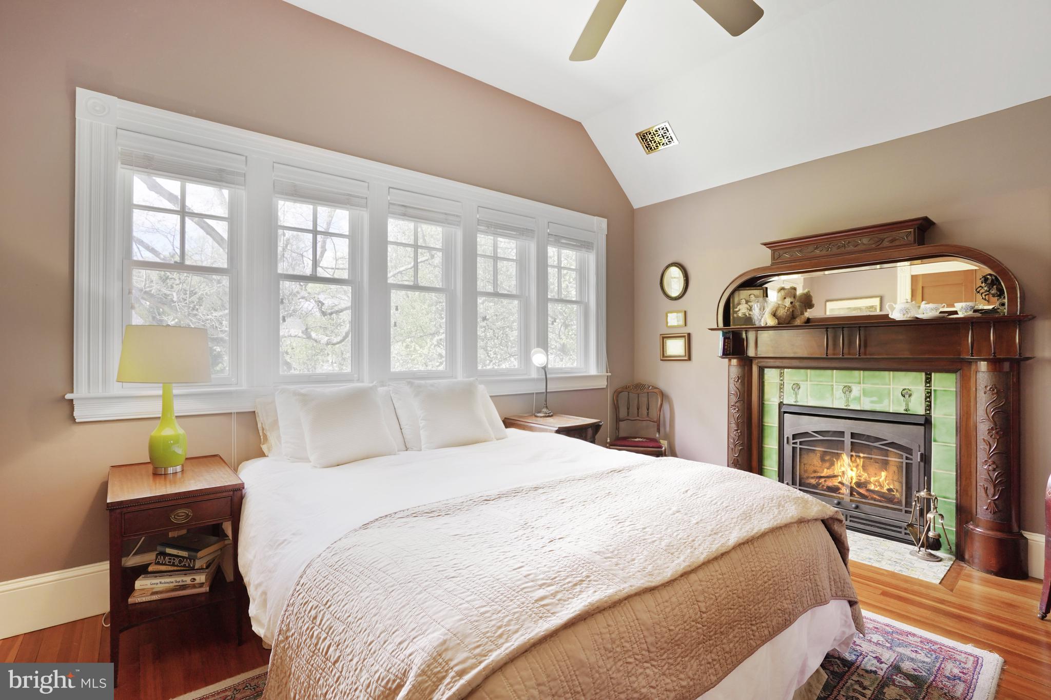 5402 Tuscarawas Road Bethesda, MD 20816 - Photo 41 of 55 a bedroom with a bed a fireplace with a large window