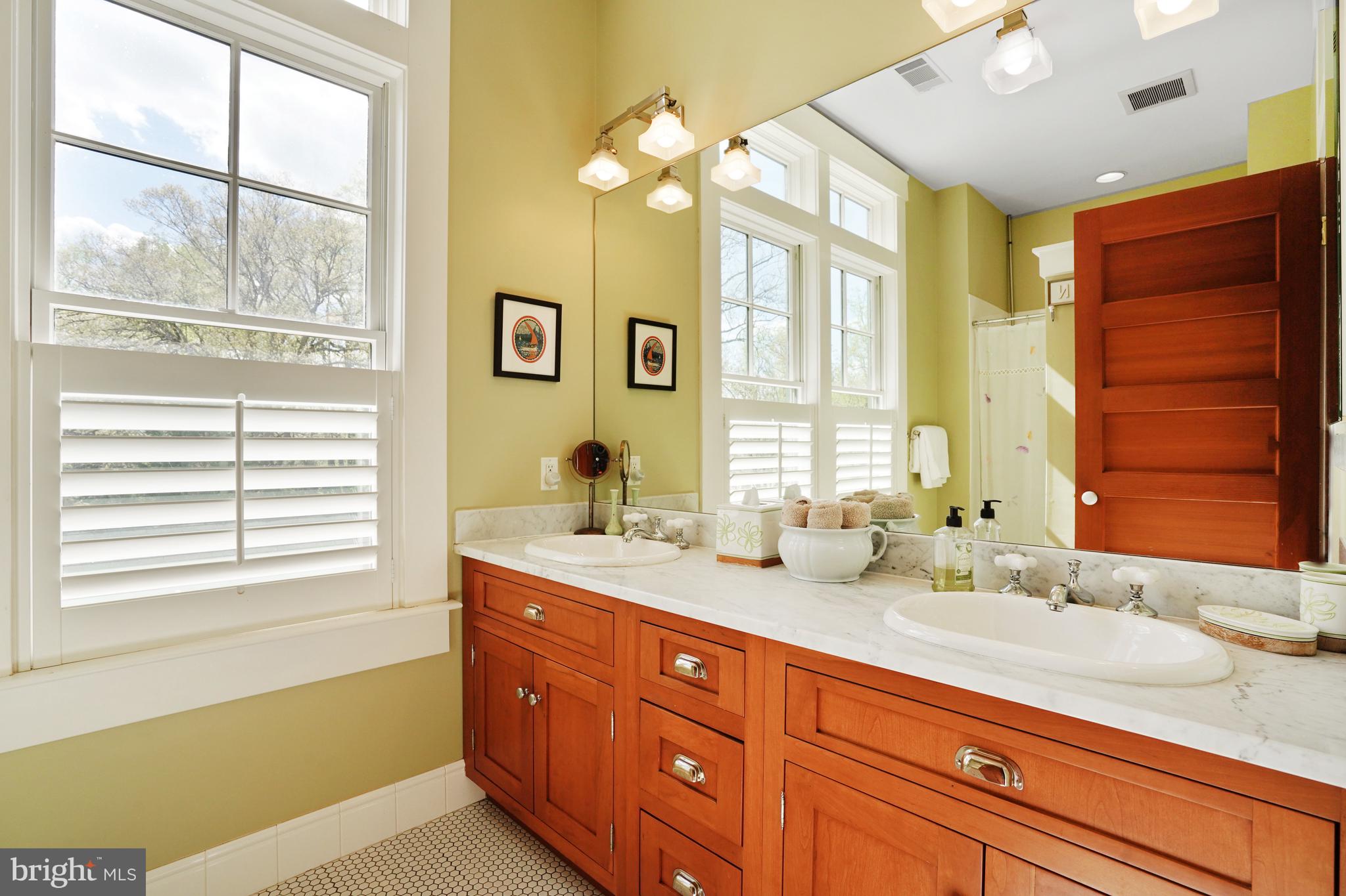5402 Tuscarawas Road Bethesda, MD 20816 - Photo 42 of 55 a bath room with a sink double vanity and a mirror