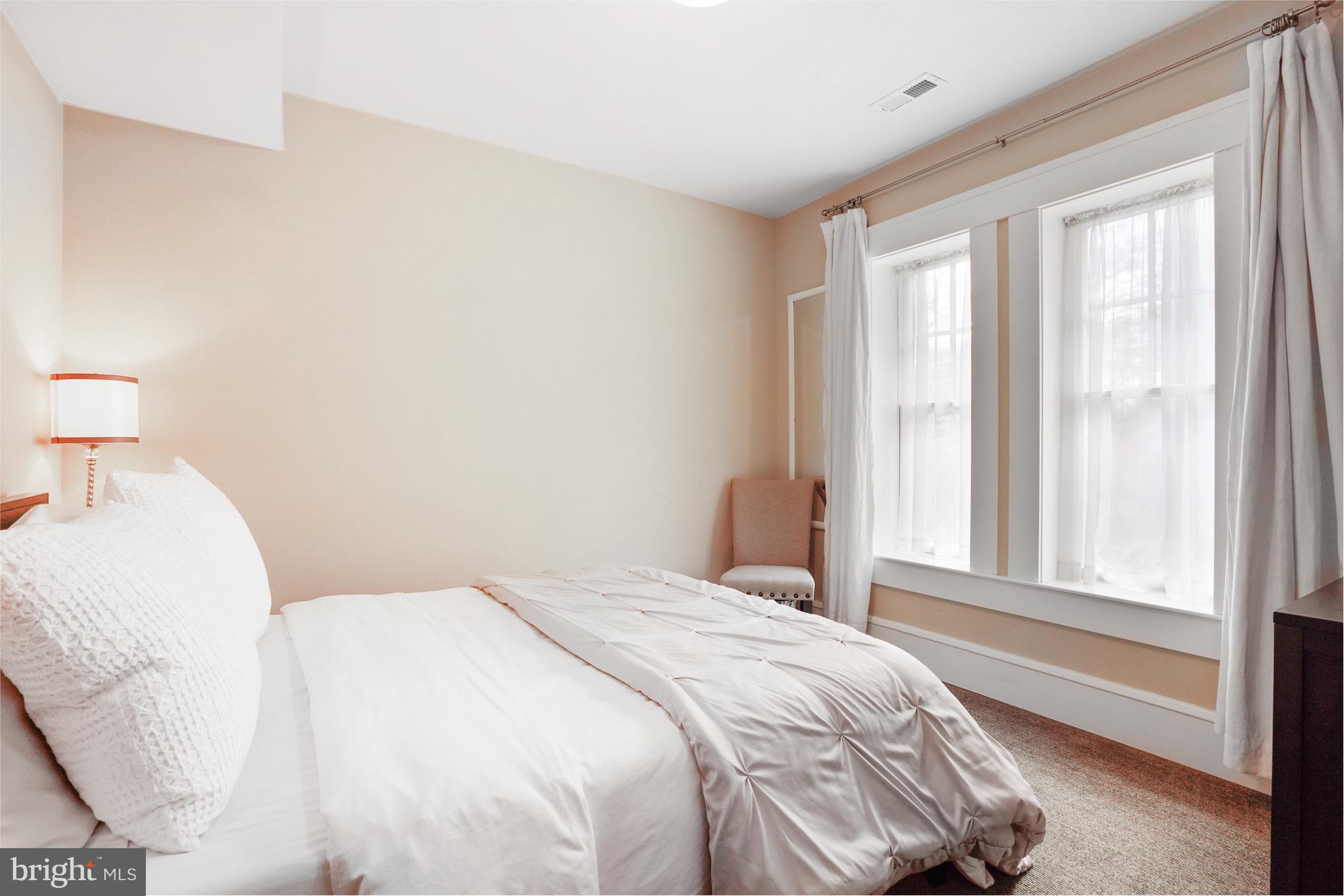 5402 Tuscarawas Road Bethesda, MD 20816 - Photo 48 of 55 a bedroom with a bed and a large window