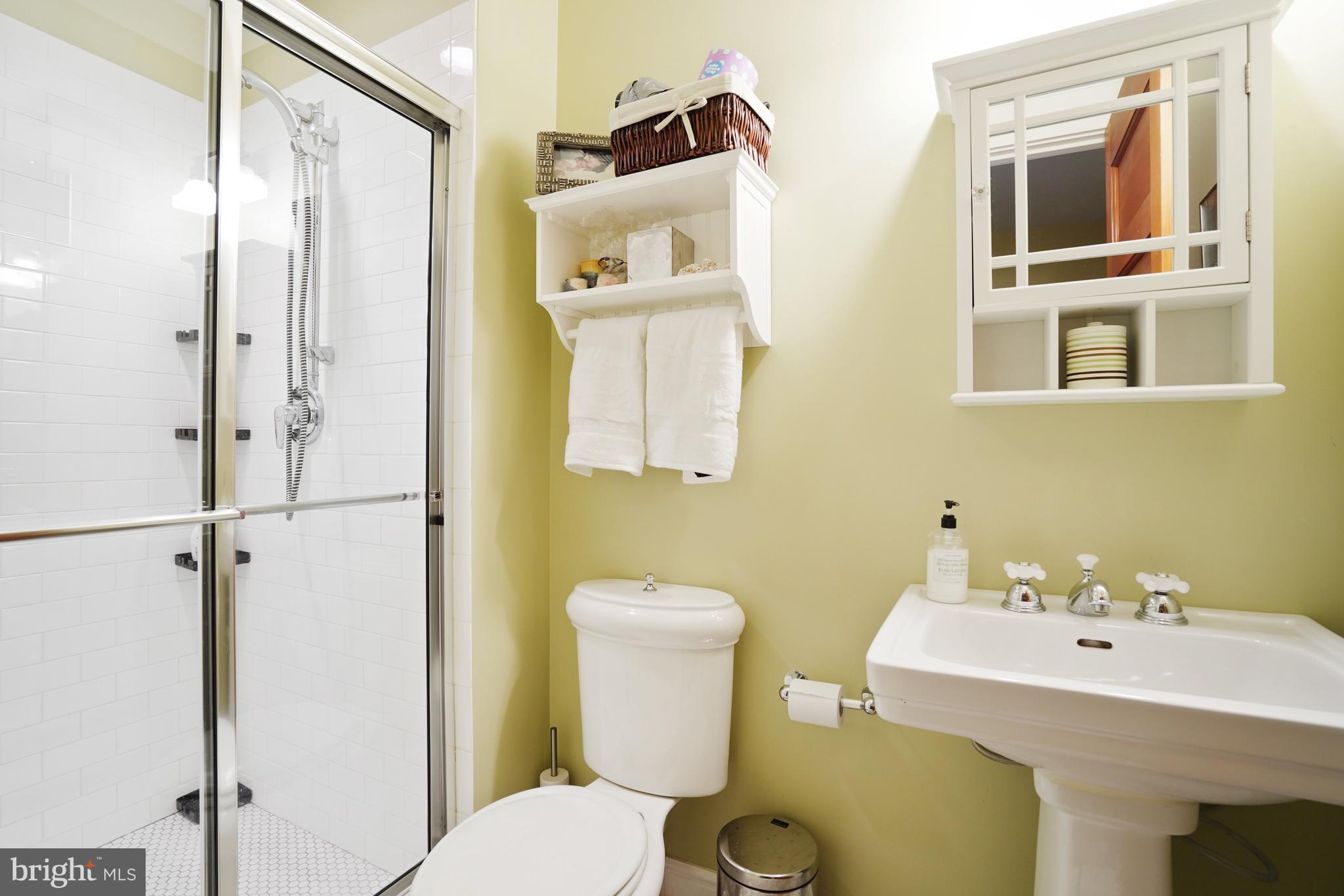 5402 Tuscarawas Road Bethesda, MD 20816 - Photo 49 of 55 a bathroom with a sink mirror and toilet