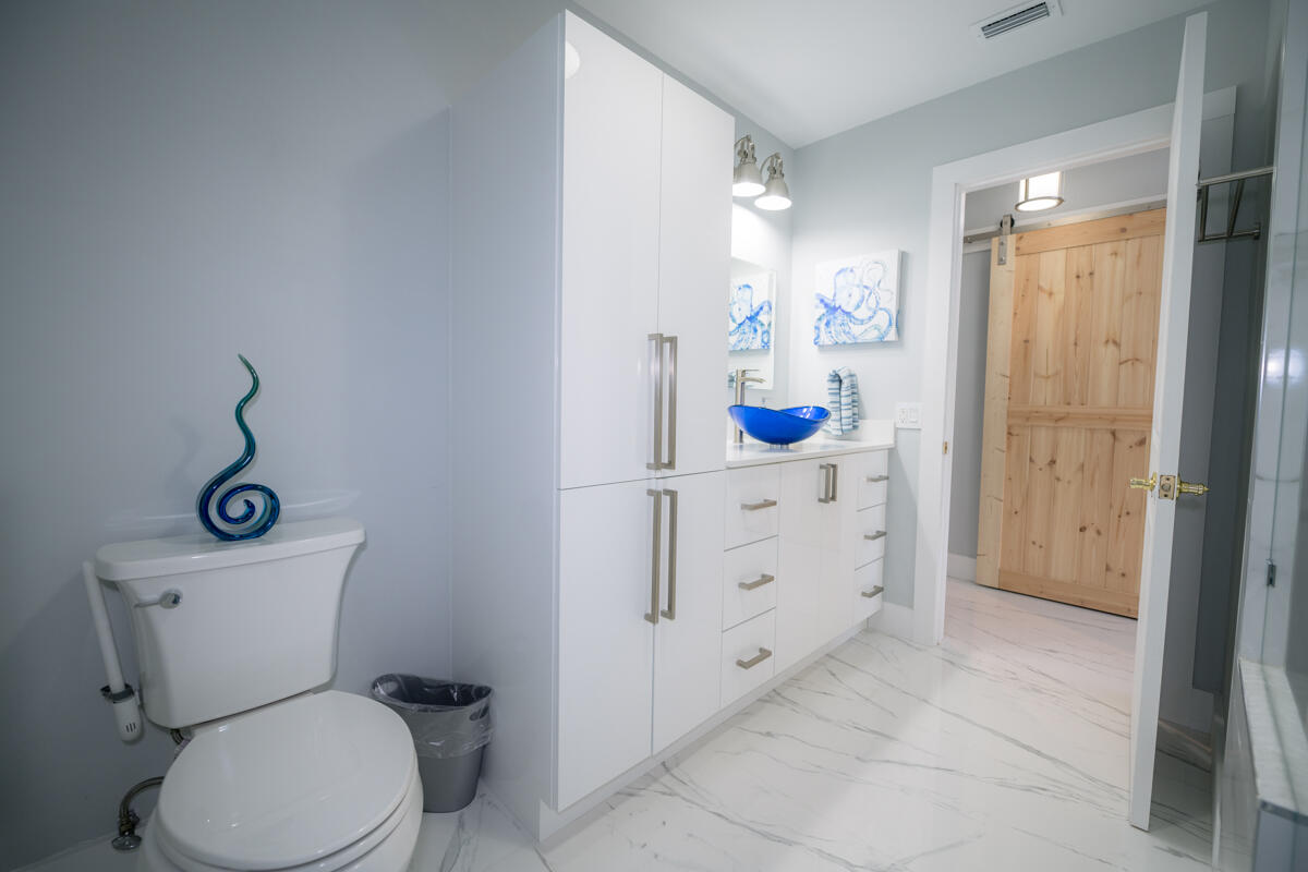 1016 Gibraltar Road Key Largo, FL 33037 - Photo 19 of 39 a bathroom with a granite countertop toilet sink and mirror