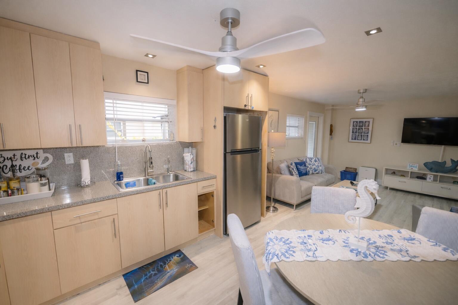1016 Gibraltar Road Key Largo, FL 33037 - Photo 22 of 39 a kitchen with stainless steel appliances kitchen island granite countertop a refrigerator oven stove a sink dishwasher and white cabinets with wooden floor