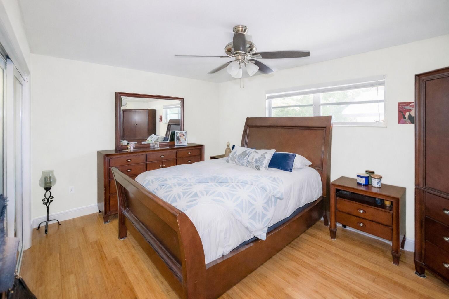 1016 Gibraltar Road Key Largo, FL 33037 - Photo 23 of 39 a bedroom with a bed and a chandelier