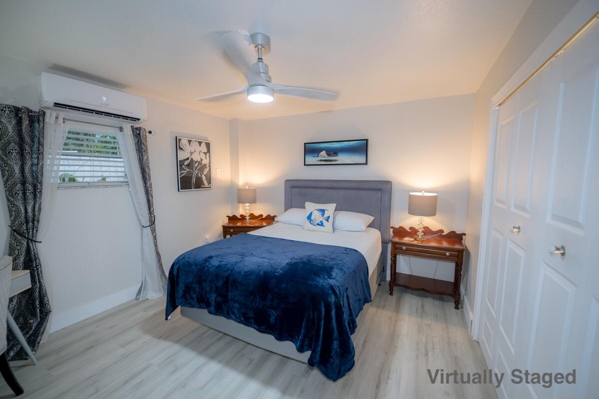 1016 Gibraltar Road Key Largo, FL 33037 - Photo 28 of 39 a bedroom with a bed and a table in it