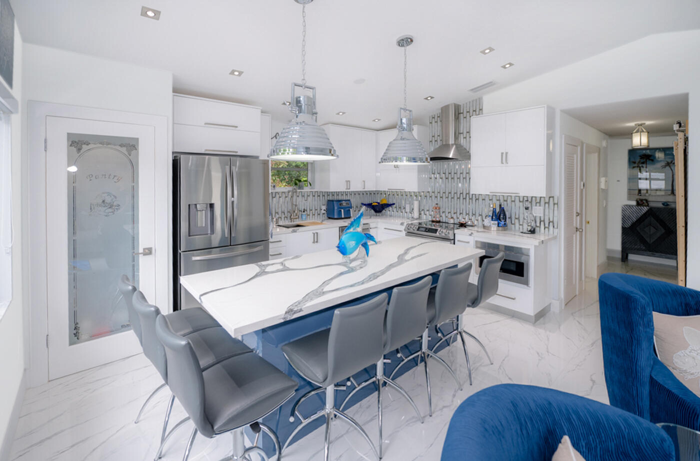 1016 Gibraltar Road Key Largo, FL 33037 - Photo 10 of 39 a kitchen with stainless steel appliances granite countertop a kitchen island a table and chairs in it
