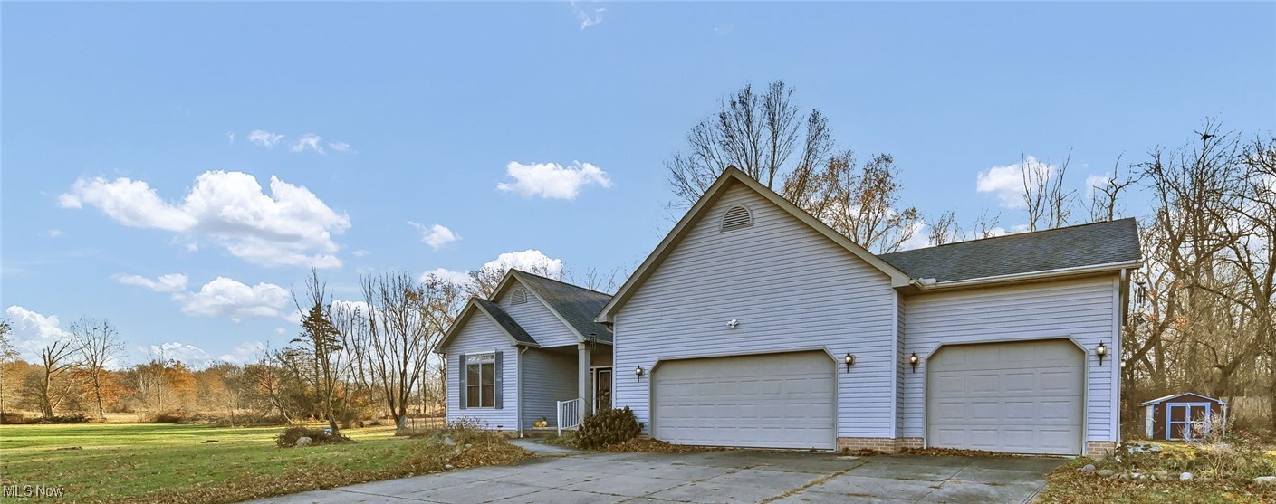 2690 Mayfair Road Akron, OH 44312 - Photo 1 of 31 Ranch-style home featuring attached three car garage, partially concrete driveway