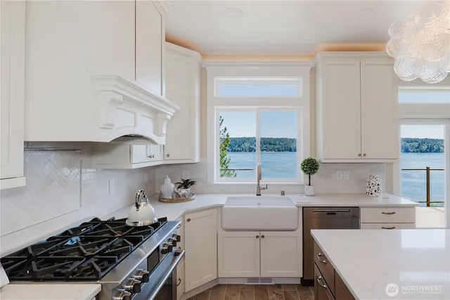 a kitchen with a sink stove top oven and cabinets