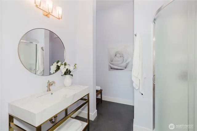 a bathroom with a sink a mirror and vanity