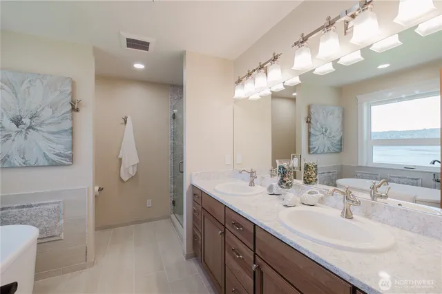 a bathroom with a double vanity sink mirror and double