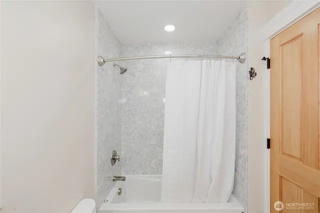 a bathroom with a shower and a tub