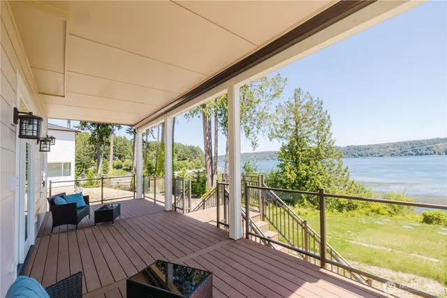 a view of a balcony with lake view and wooden floor