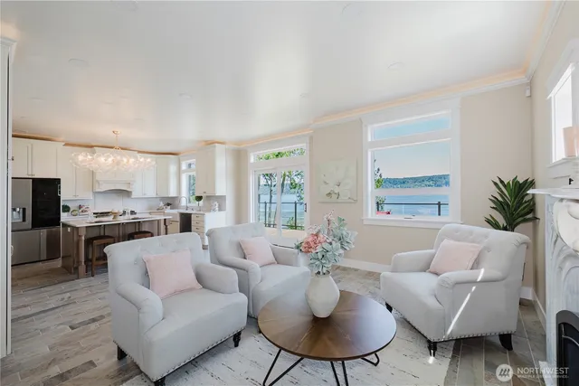 a living room with furniture kitchen view and a large window