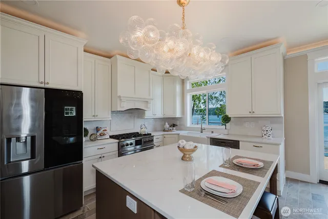 a kitchen with a white center island and cabinets