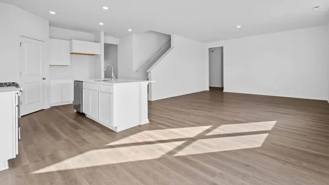 a view of kitchen with wooden floor and electronic appliances