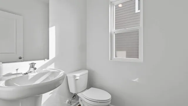 a bathroom with a sink toilet and a mirror
