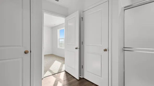 a view of an empty room and wooden floor