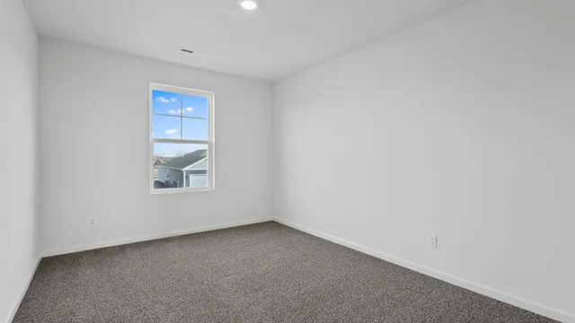 a view of an empty room and a window