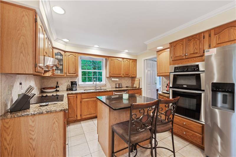 4914 Simmons Circle Export, PA 15632 - Photo 12 of 33 a kitchen with stainless steel appliances granite countertop a stove a sink a microwave and a refrigerator