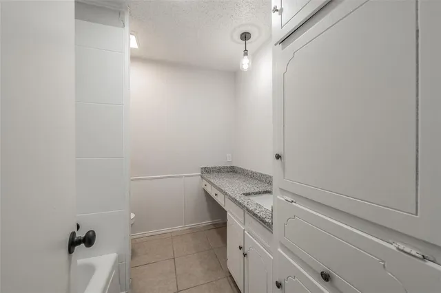 a bathroom with a granite countertop sink and vanity