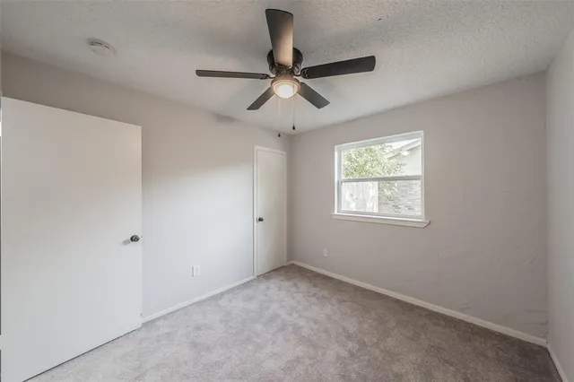 an empty room with ceiling fan