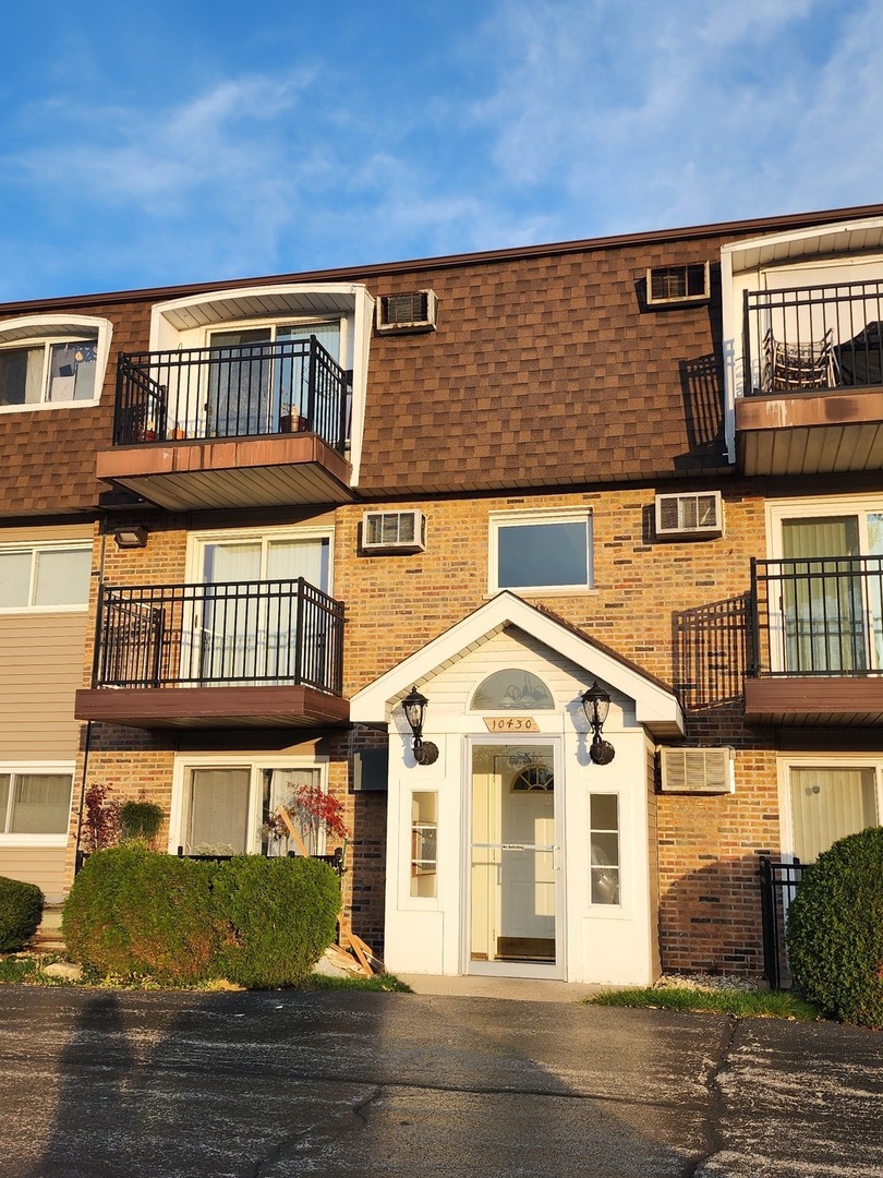 10430 Ridgeland Avenue, Unit 11 Chicago Ridge, IL 60415 - Photo 1 of 1 a front view of residential houses with street