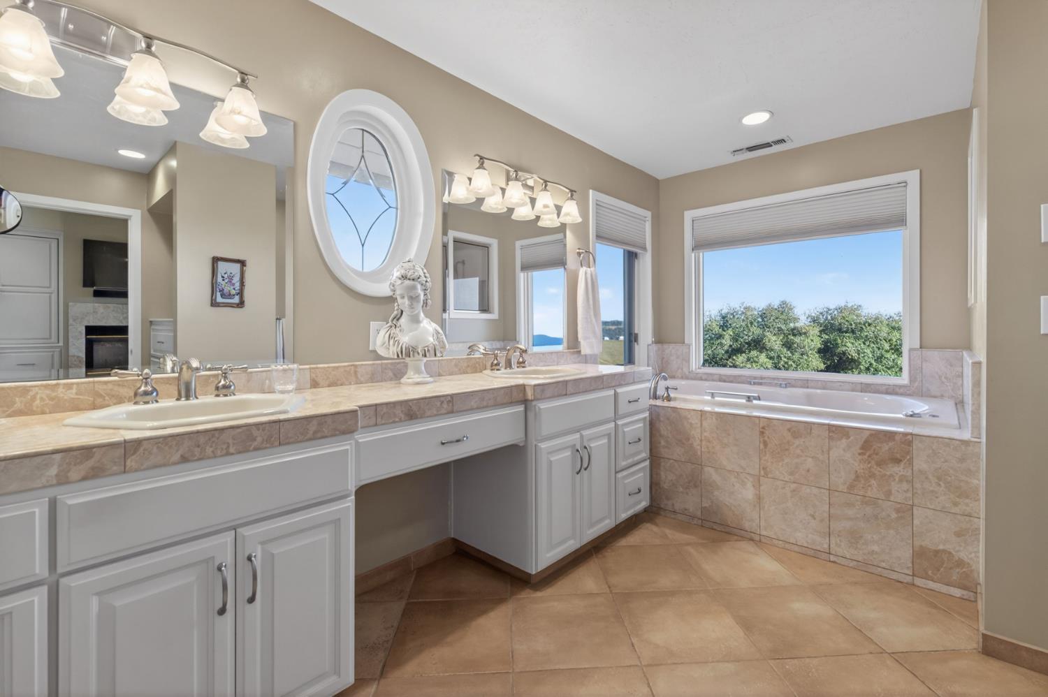 7570 Airola Road Vallecito, CA 95251 - Photo 41 of 90 a bathroom with a double vanity sink and a large mirror