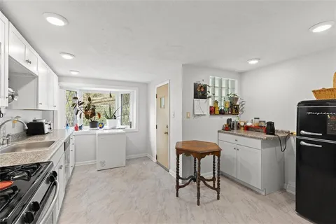 a kitchen with a sink cabinets and wooden floor