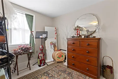 a bedroom with furniture and a gym machine