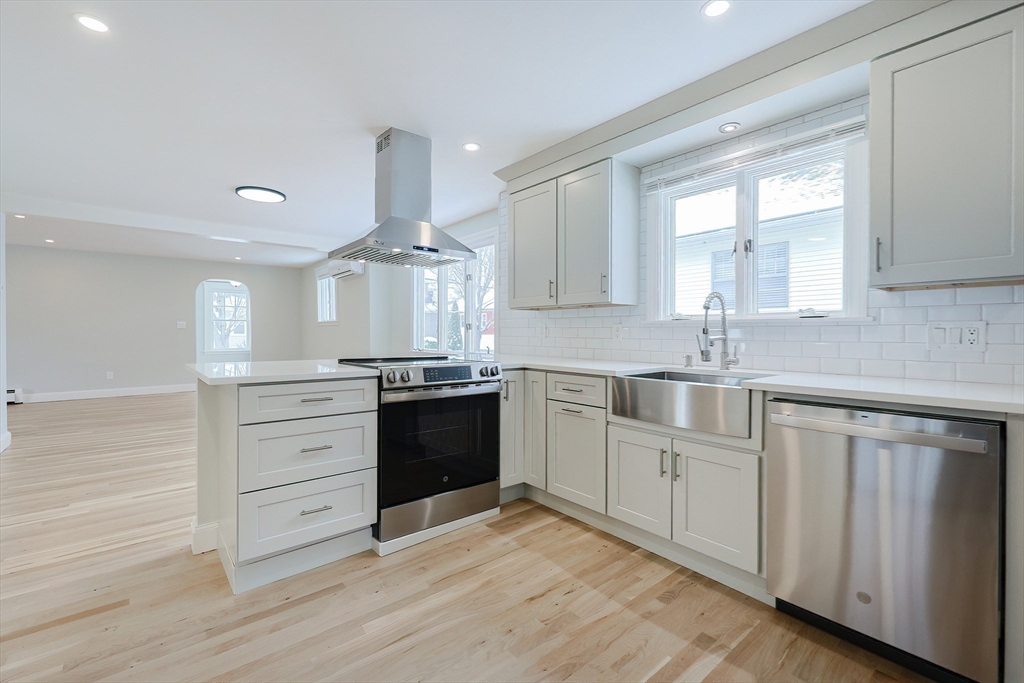 19 Arlington Road Waltham, MA 02453 - Photo 15 of 40 a kitchen with granite countertop a sink stainless steel appliances and cabinets