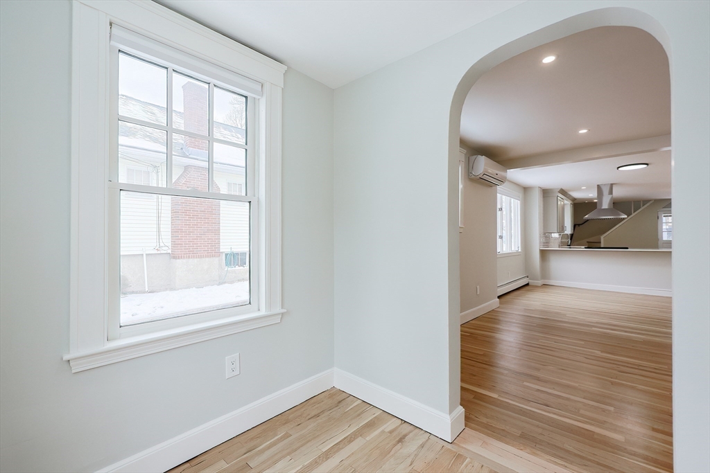 19 Arlington Road Waltham, MA 02453 - Photo 8 of 40 an empty room with wooden floor and windows