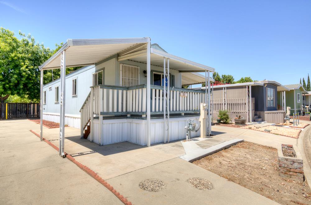a view of a house with wooden fence