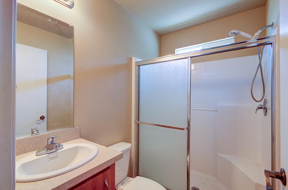 1218 East Cleveland Avenue, Unit 23 Madera, CA 93638 - Photo 13 of 14 a bathroom with a sink toilet and shower
