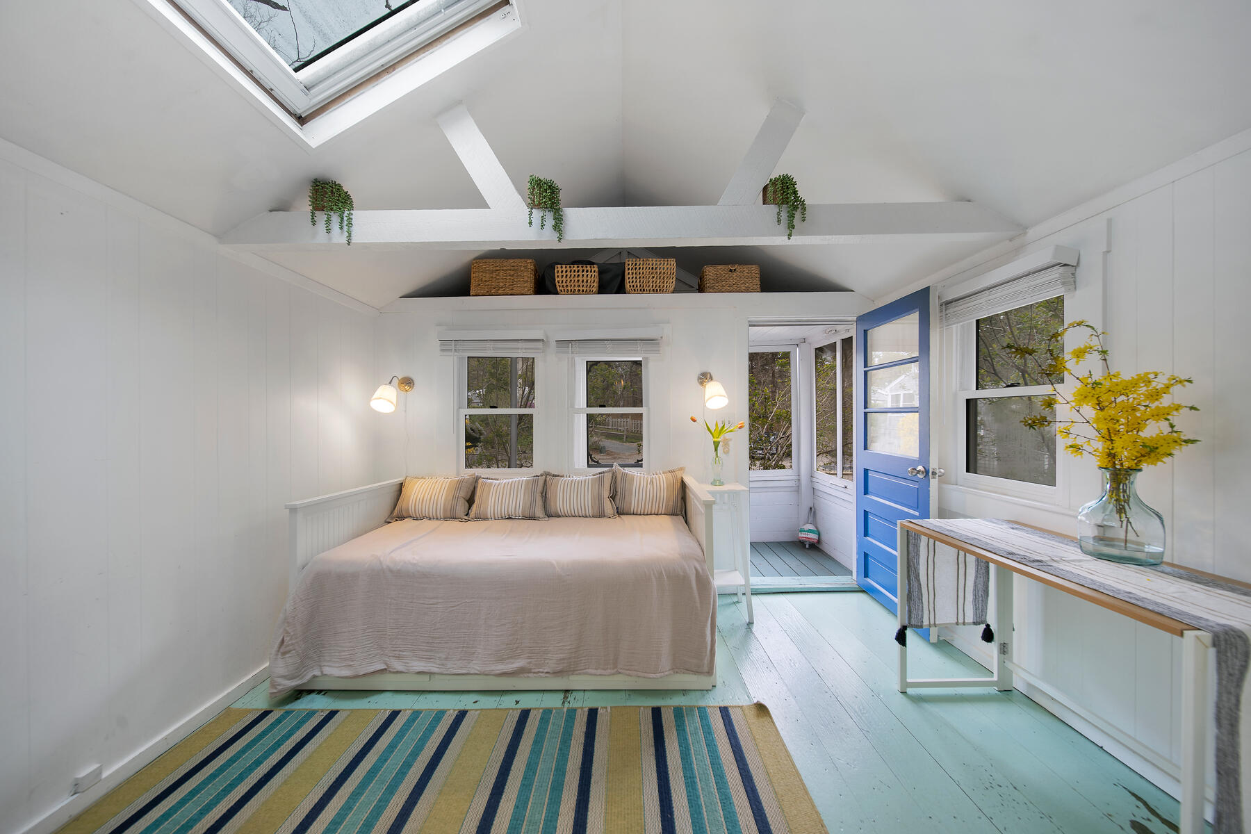 82 Shore Road, Unit 9 Truro, MA 02666 - Photo 1 of 36 a spacious bedroom with a bed and a chandelier