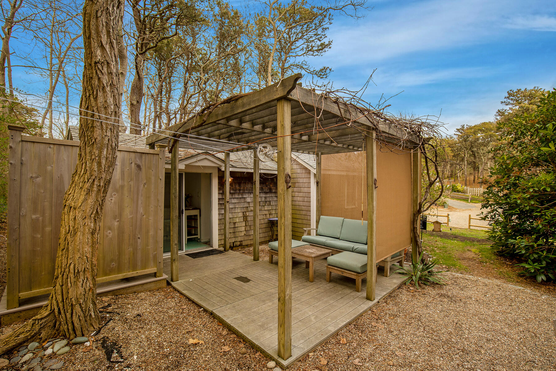 82 Shore Road, Unit 9 Truro, MA 02666 - Photo 20 of 36 a view of a house with backyard and sitting area