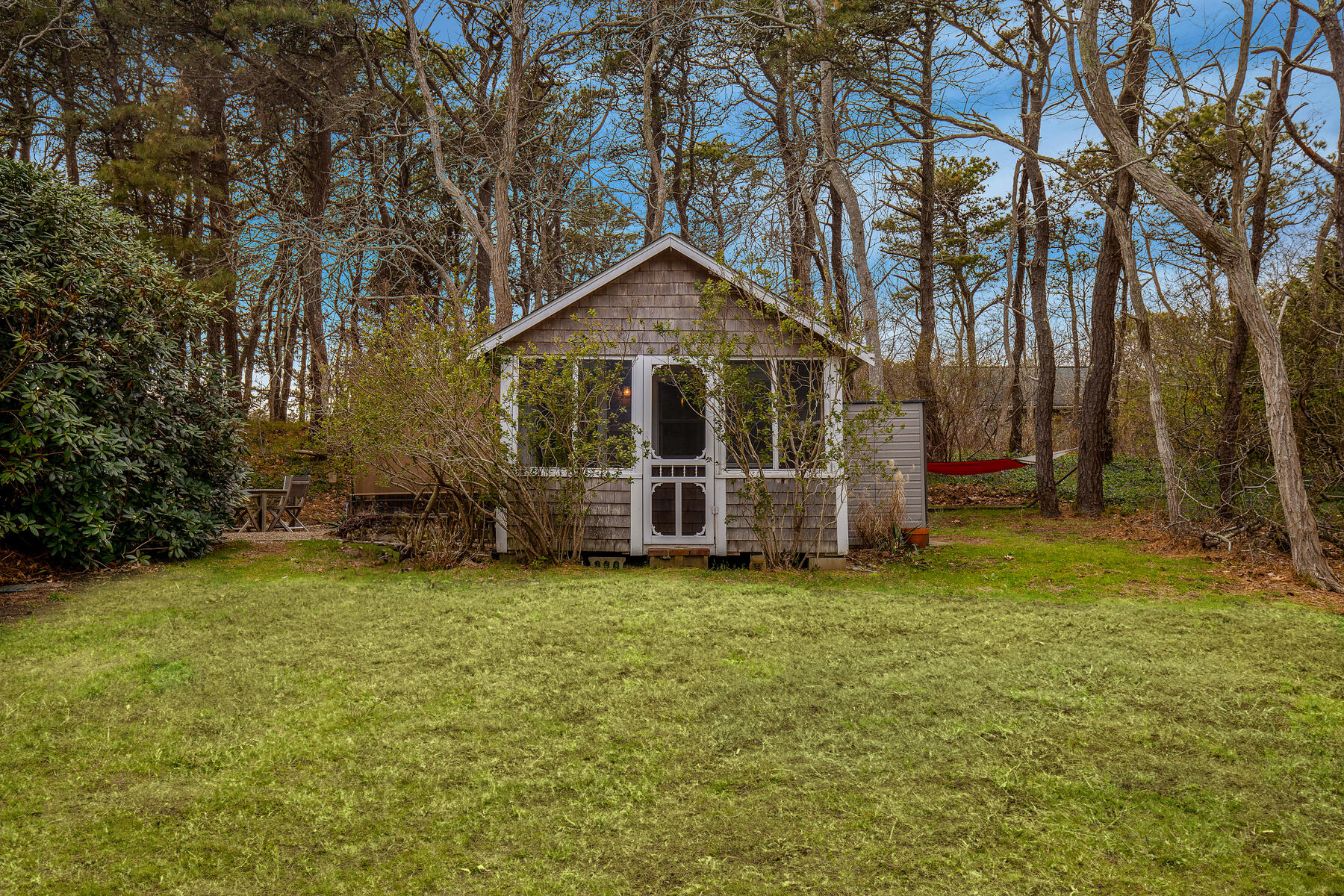82 Shore Road, Unit 9 Truro, MA 02666 - Photo 31 of 36 a view of a house with a yard and large trees