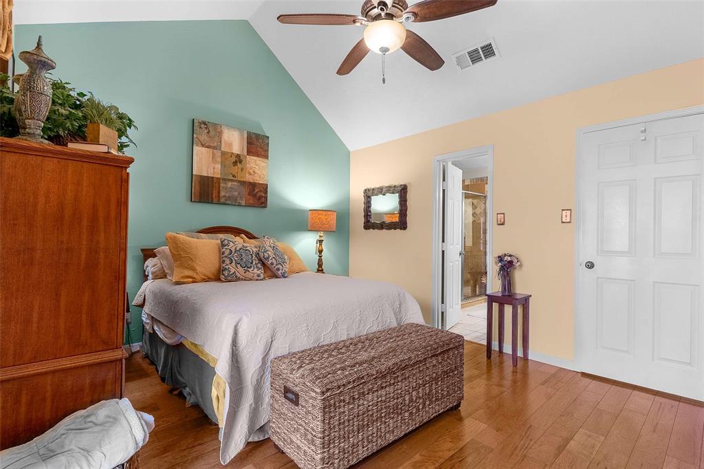 14683 Plage Lane Addison, TX 75001 - Photo 11 of 39 Bedroom featuring lofted ceiling, wood finished floors, and a ceiling fan