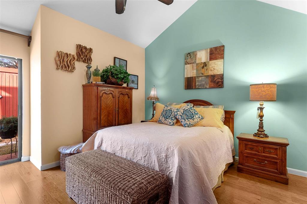 14683 Plage Lane Addison, TX 75001 - Photo 12 of 39 Bedroom featuring access to outside, lofted ceiling, light wood finished floors, and ceiling fan