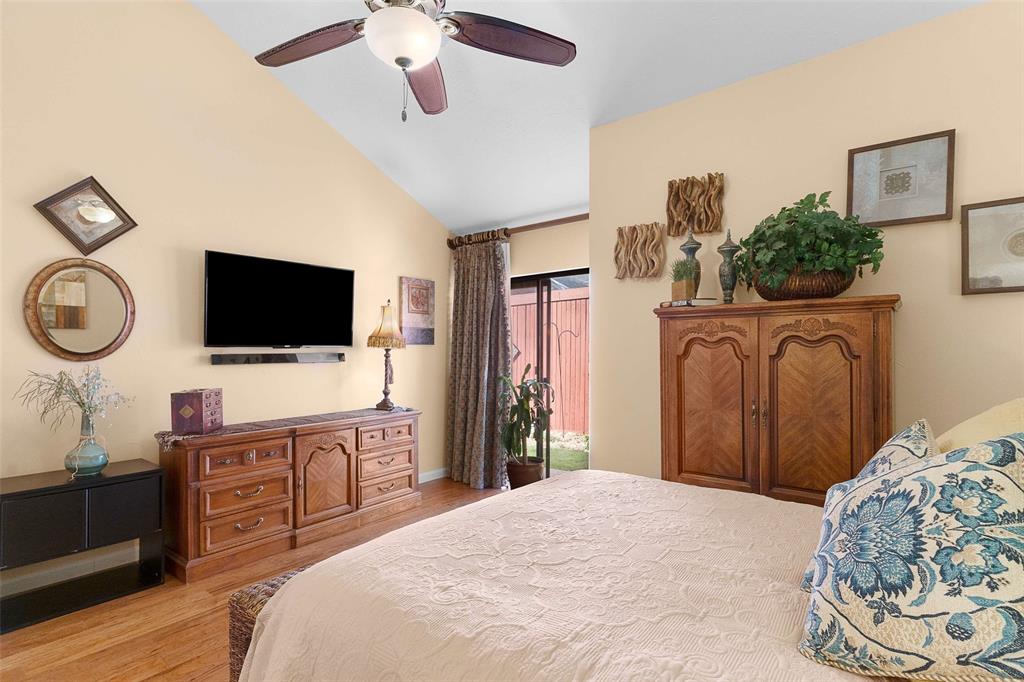 14683 Plage Lane Addison, TX 75001 - Photo 13 of 39 Bedroom with access to outside, light wood-style flooring, lofted ceiling, and ceiling fan