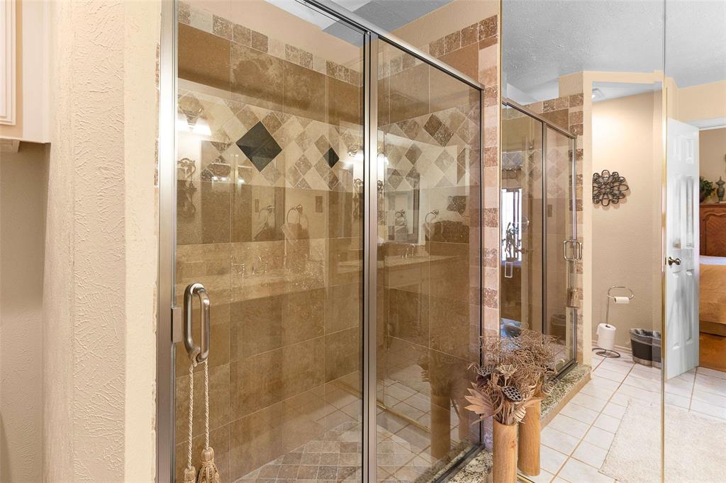 14683 Plage Lane Addison, TX 75001 - Photo 15 of 39 Ensuite bathroom featuring a shower stall and light tile patterned floors