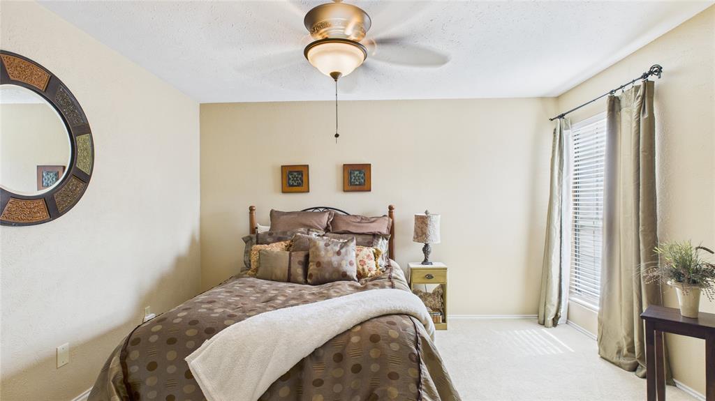 14683 Plage Lane Addison, TX 75001 - Photo 16 of 39 Bedroom featuring light carpet and ceiling fan