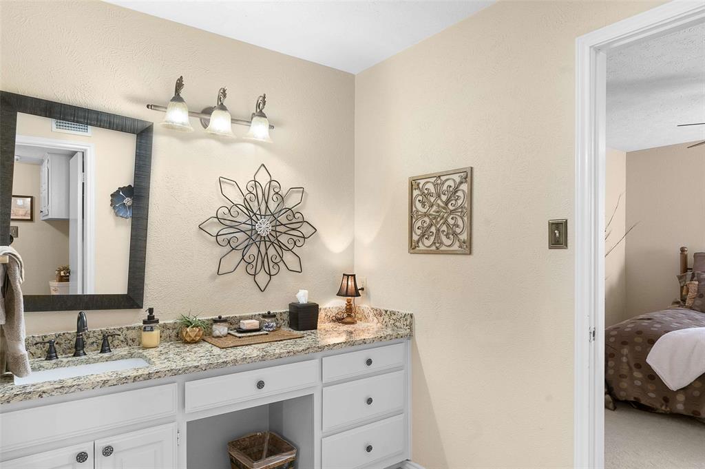 14683 Plage Lane Addison, TX 75001 - Photo 17 of 39 Ensuite bathroom featuring vanity and a textured wall